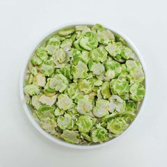 GuineaDad pea flakes on plate, appealing crunchy reward for guinea pigs.