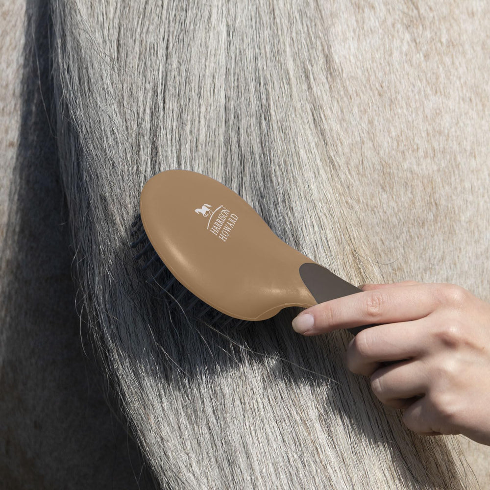 Harrison Howard brush in use on a horse mane, showcasing easy grooming on the move.