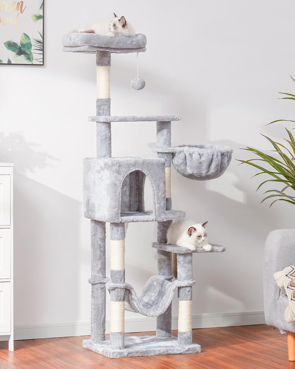 Hey-brother cat tree pompoms add playful texture to the living space