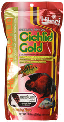 Hikari Cichlid Gold pellets poured into a tank for easy feeding control.