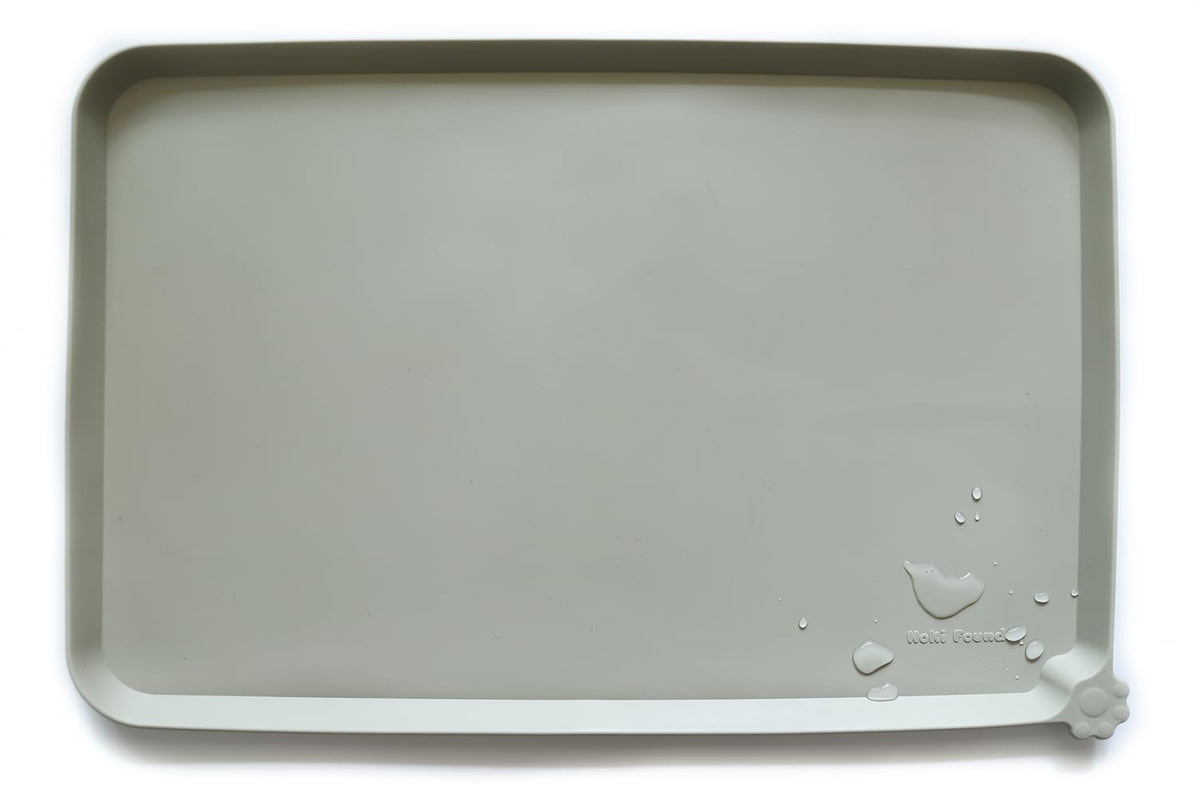 Hoki Found L silicone non-slip bowl mat in cream-green with raised edge prevents spills.