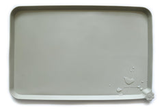 Hoki Found L silicone non-slip bowl mat in cream-green with raised edge prevents spills.