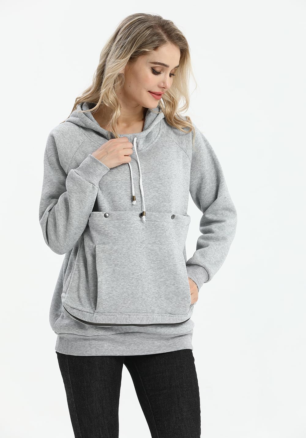 Kei Tomlison pouch hoodie hands-free walking with pets in daylight.