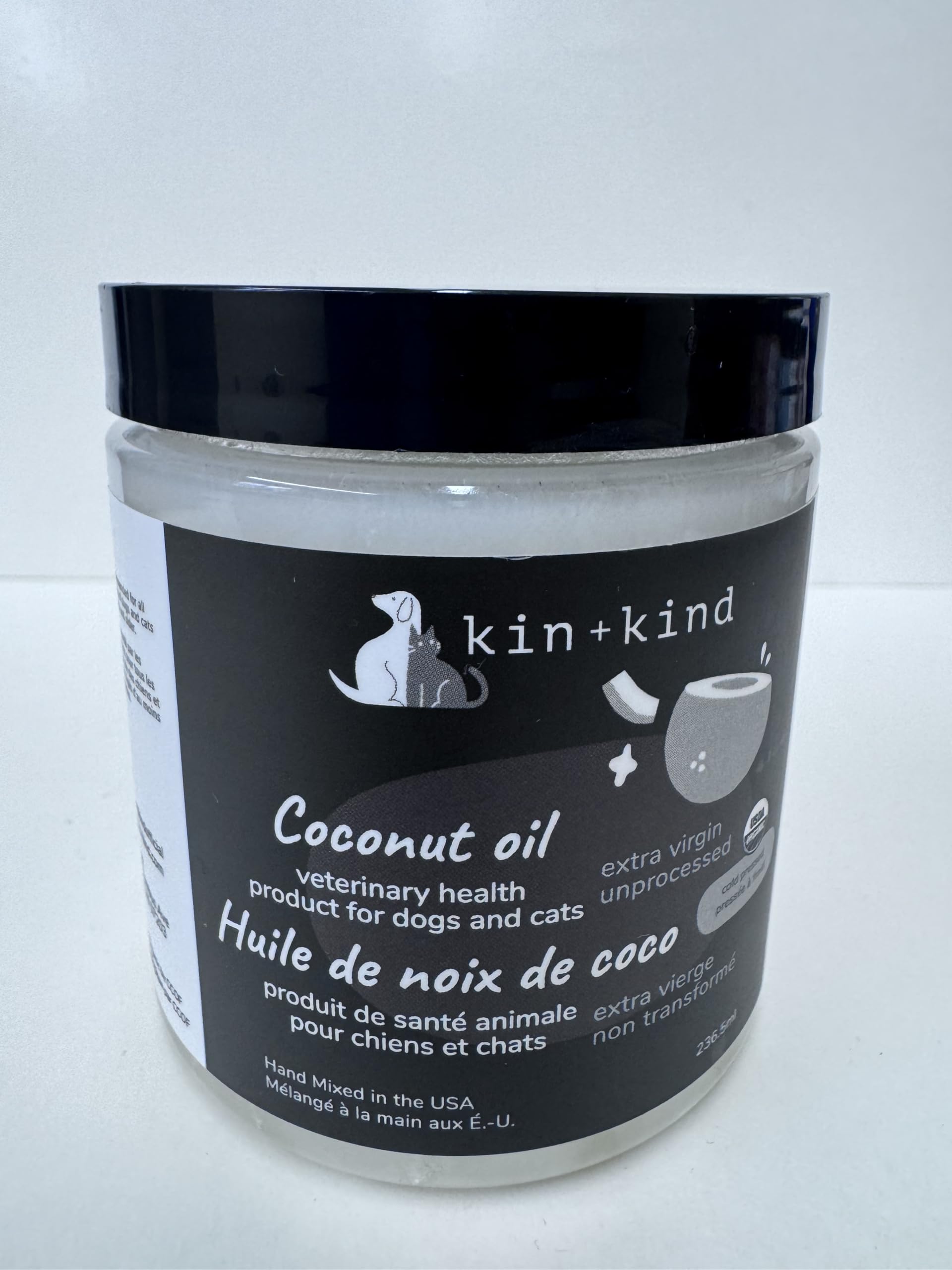 Kin-kind coconut oil being added to pet meals for coat support.