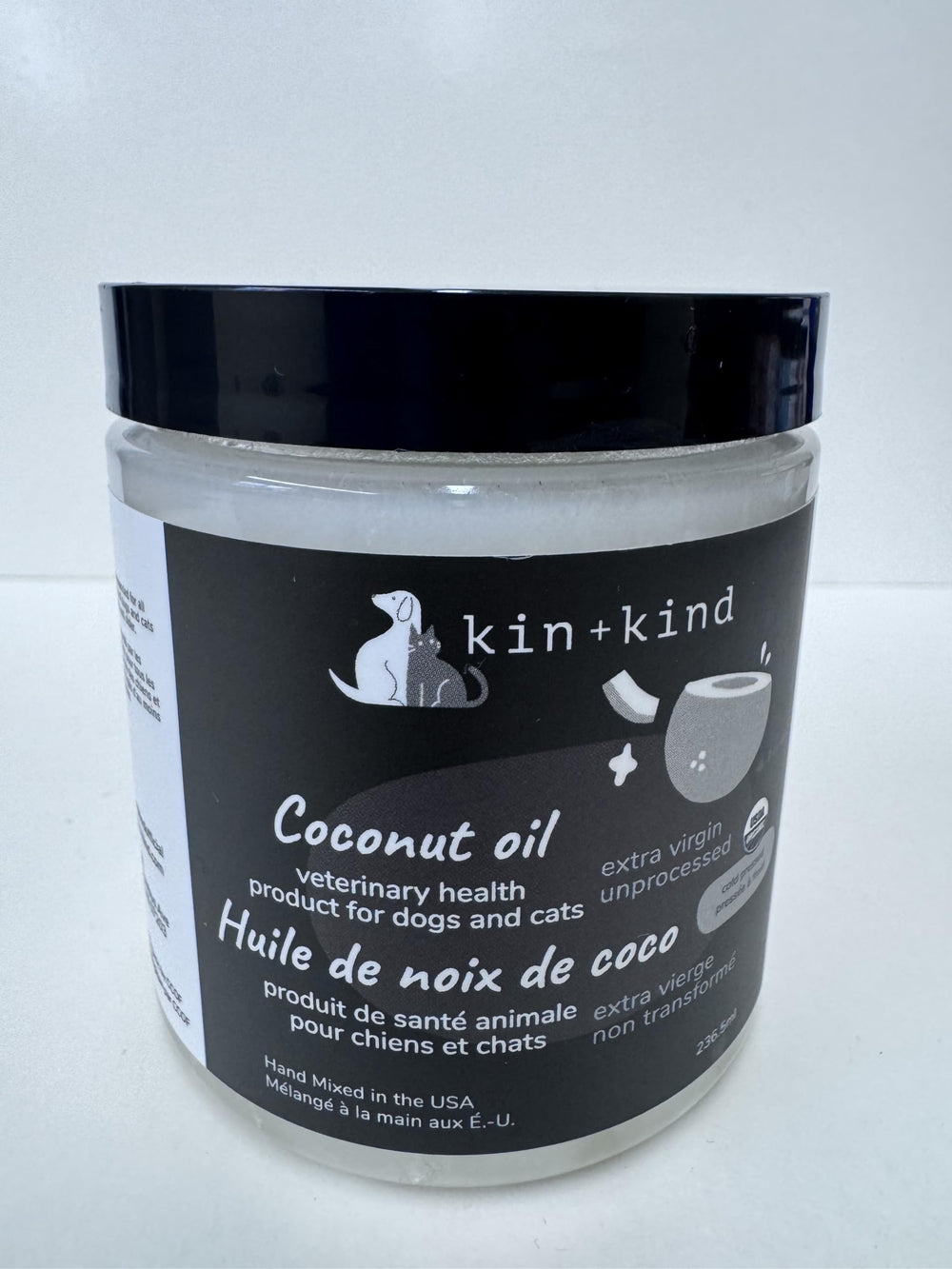 Kin-kind coconut oil being added to pet meals for coat support.