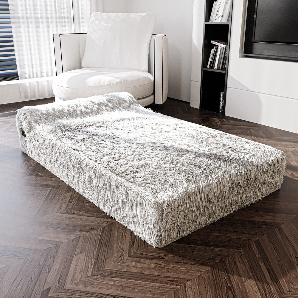 KOPEKS large 50x34 bed photographed in fluffy grey textile for spacious lounging.