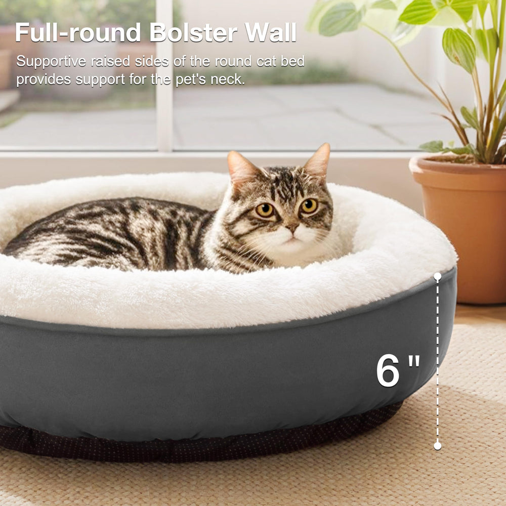 Love's cabin round-donut-bed water-resistant-bottom keeps paws dry after spills.