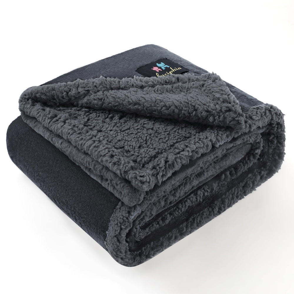 Luciphia waterproof bed blanket folded in grey protects furniture from spills.
