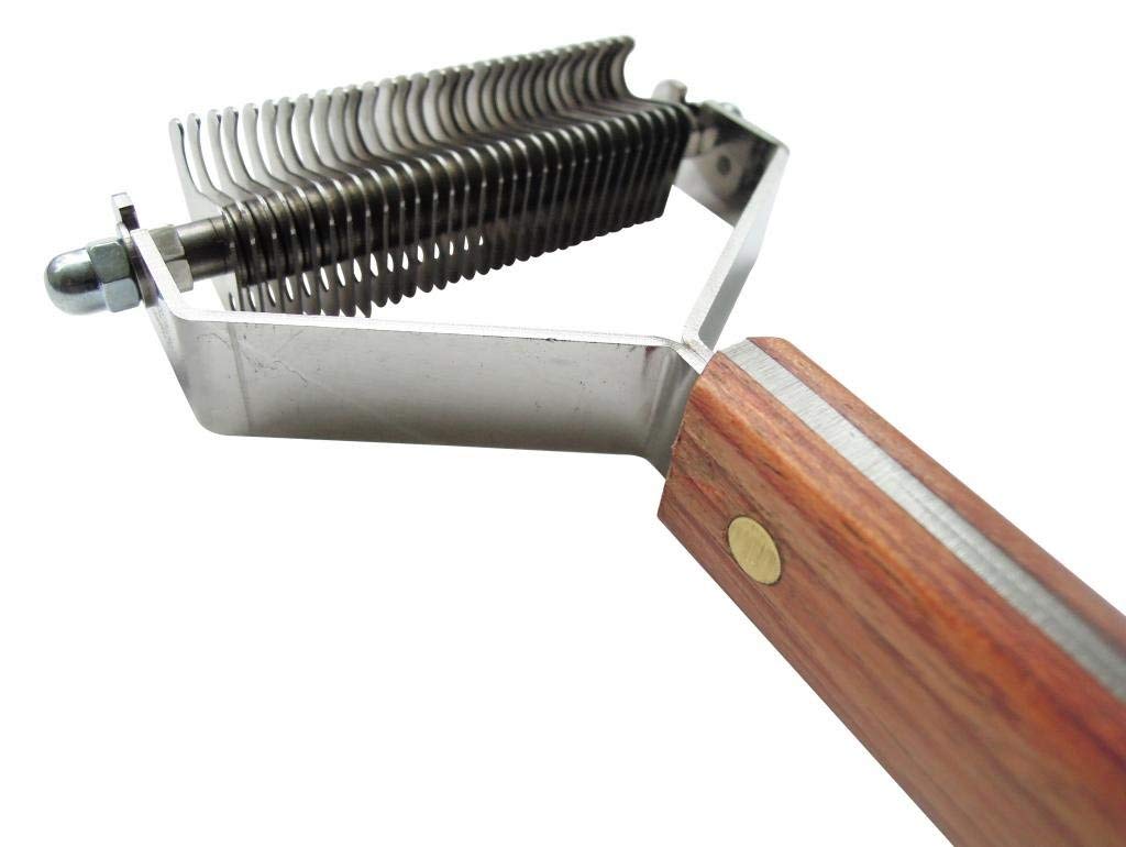 Mars Coat King dematting rake in use on a dog coat for fast grooming