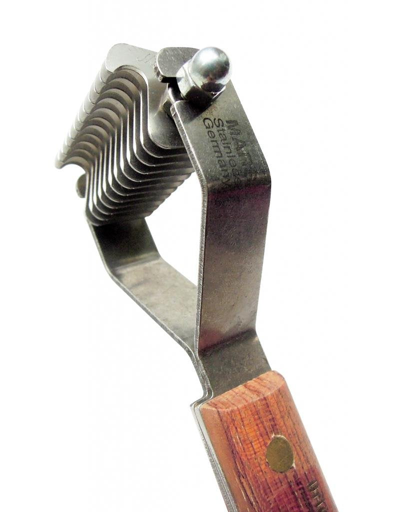 Mars Coat King grooming tool in use shows gentle deshedding for pets.
