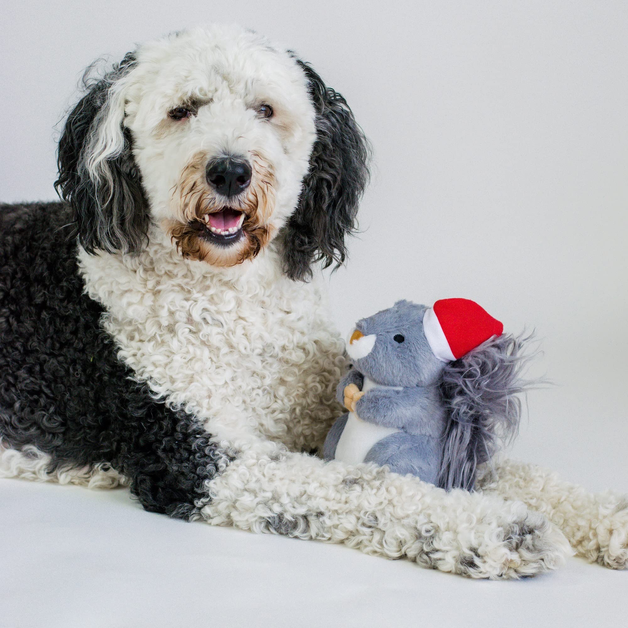 Midlee Christmas squirrel toy under tree evokes festive gift moments.