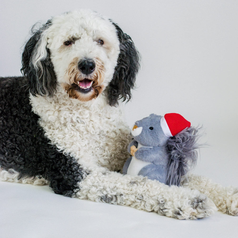 Midlee Christmas squirrel toy under tree evokes festive gift moments.