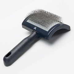 Millers Forge curved slicker brush in use helps remove mats and loose fur