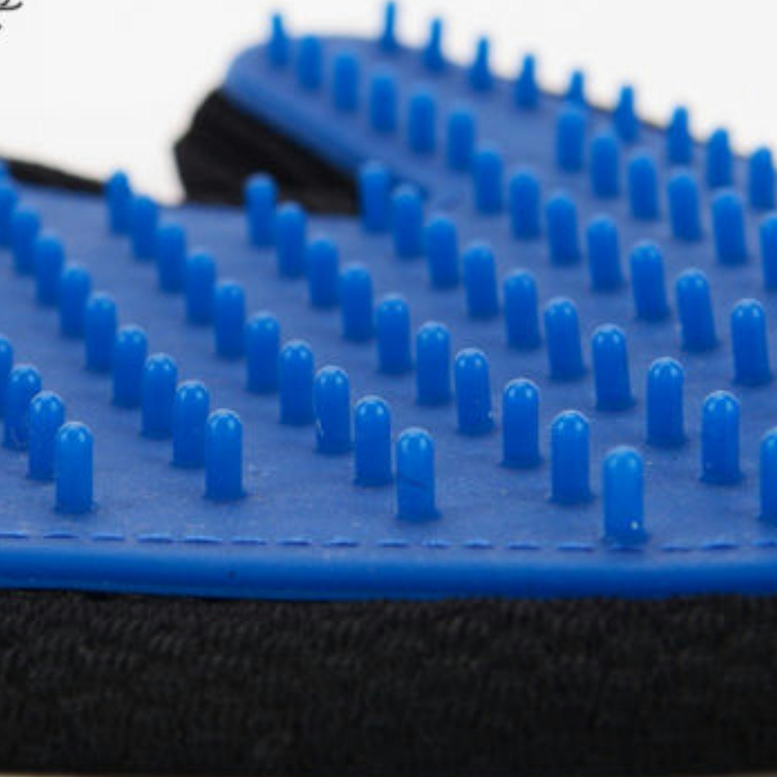 Mr. Peanut's grooming glove worn on hand showing secure fit for grooming sessions.