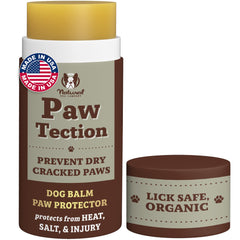Natural Dog Company PawTection Balm stick applied to a paw for quick protection.