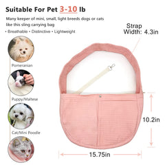 NATUYA pink canvas dog sling worn on shoulder for an outdoor stroll.