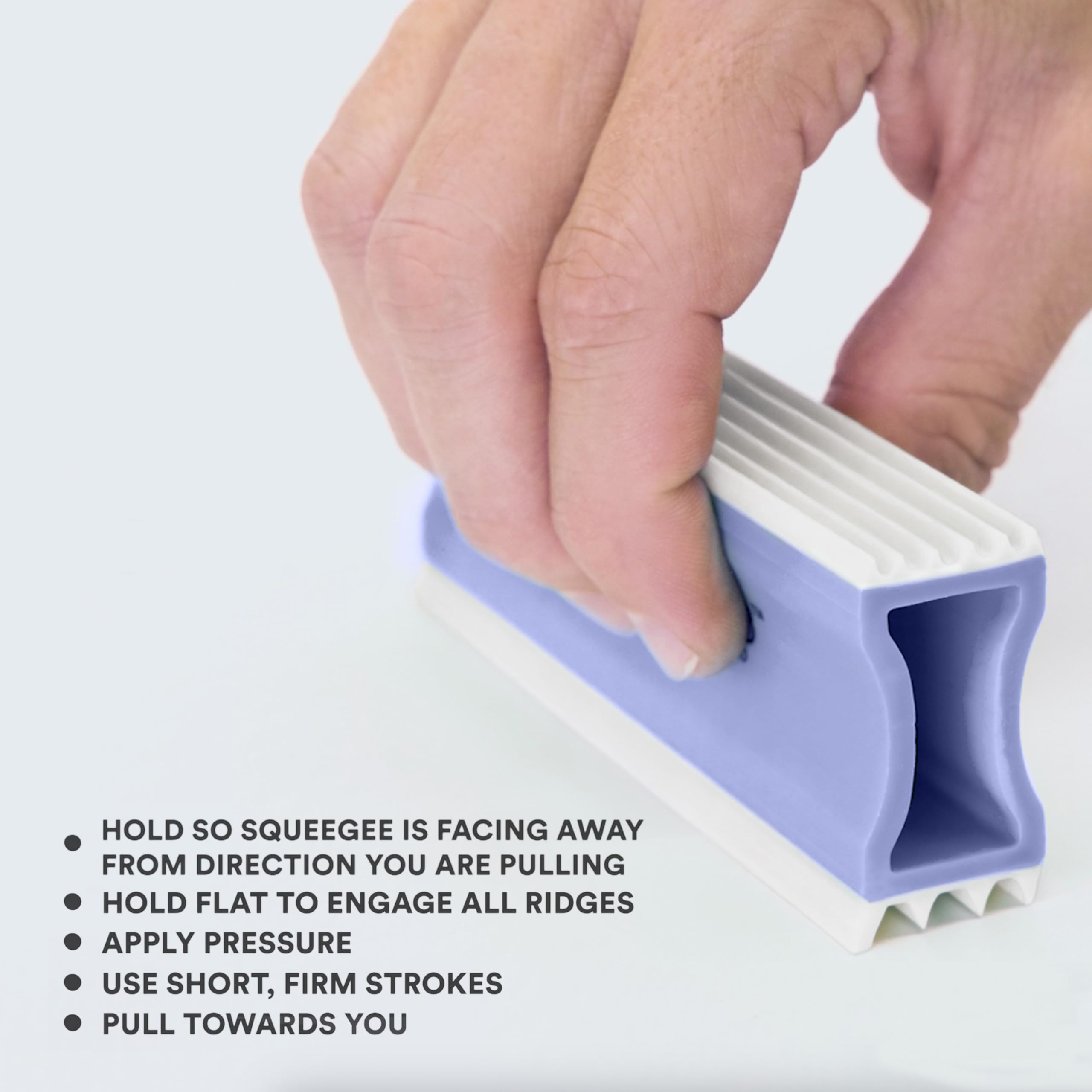 Couch hair removal close-up highlights embedded fibers lifted by gentle rubber