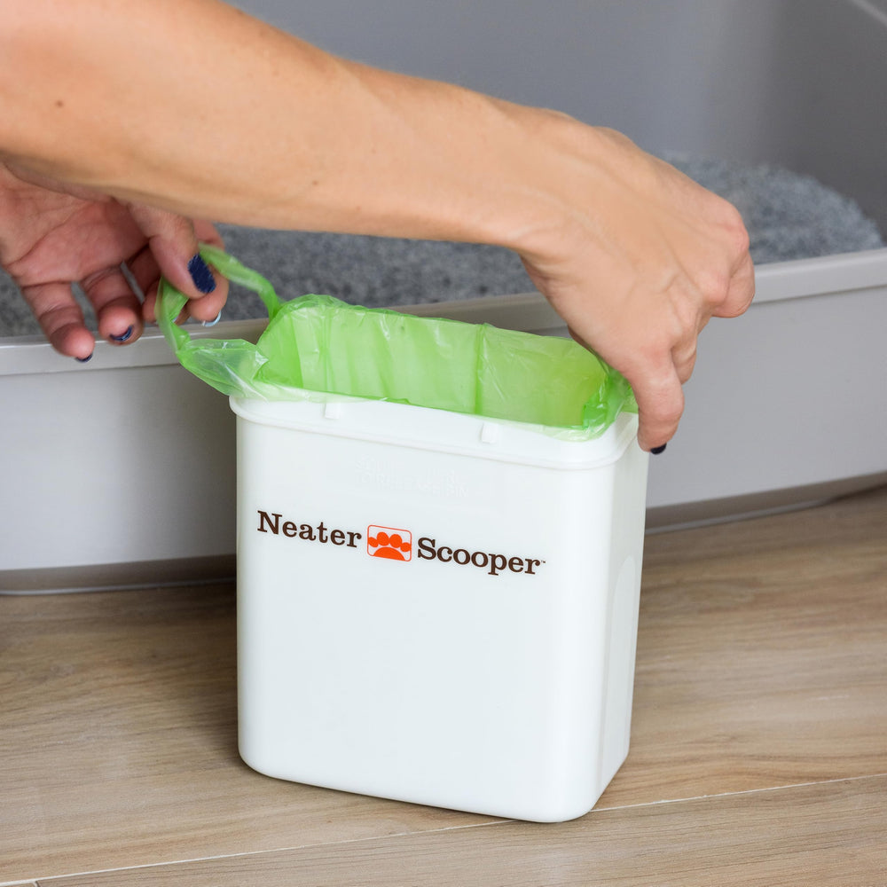 Neater Pets green tie-handle bags for quick, hygienic trash sealing.