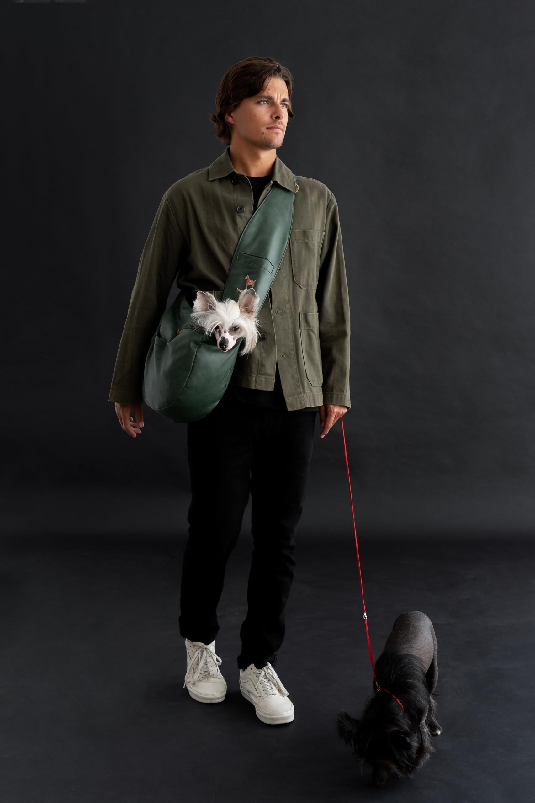 Noah & Paw dog sling carrier side view highlights adjustable strap for tailored fit during walks.