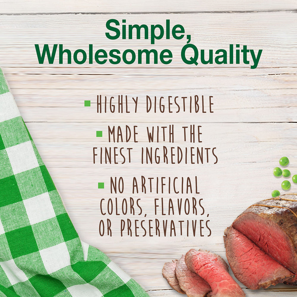 Dog chewing Nylabone Healthy Edibles roast beef chew in home setting.