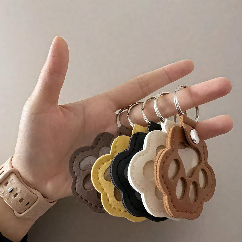 Paw-shaped leather pet fur keychain closeup showcases craftsmanship and secure hardware