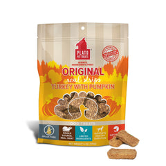 PLATO Real Strips Turkey & Pumpkin bag on counter, grain-free dog treats for easier chewing