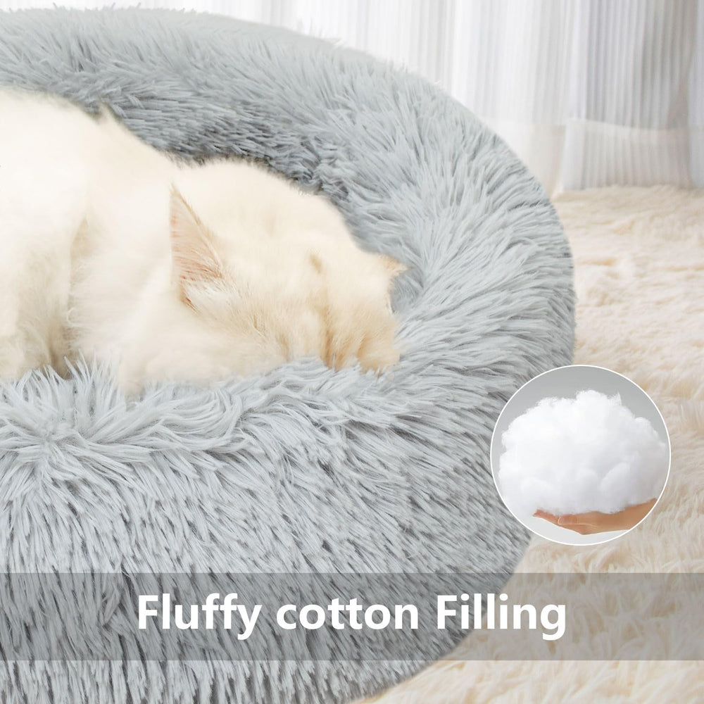 Qinxuepet donut bed raised edges provide gentle head support for restful naps.