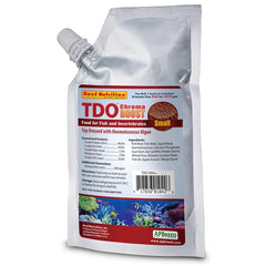 Reed Mariculture TDO Chroma Boost pellet closeup showing astaxanthin-rich color enhancement for small reef fish
