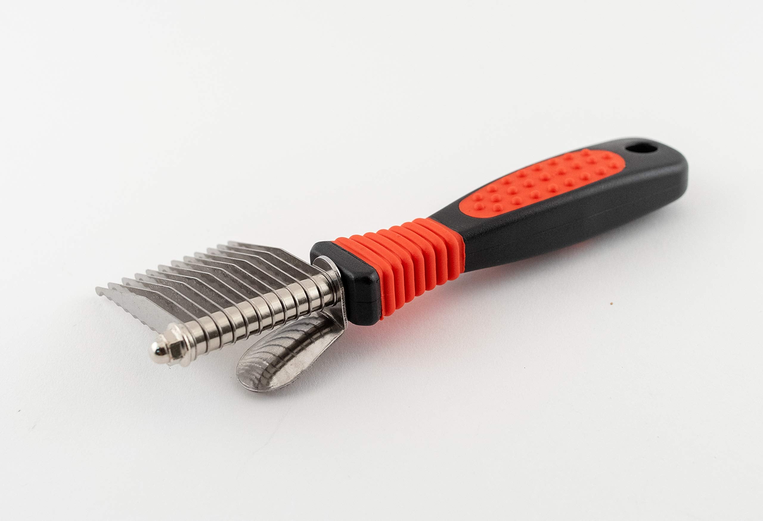 RYAN'S PET SUPPLIES Paw Brothers dematting tool with ergonomic handle shown during grooming session.
