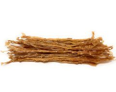 Sancho and Lola's Closet turkey tendons in use on a happy chewing dog.