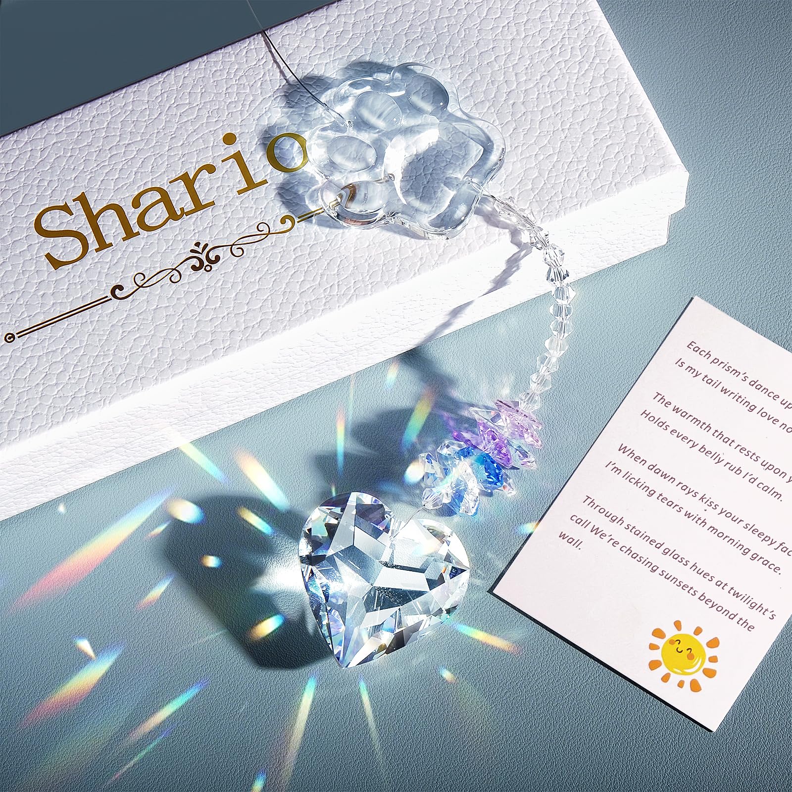 Shario paw-etched crystal suncatcher captures light with a paw design for cherished dog memories.