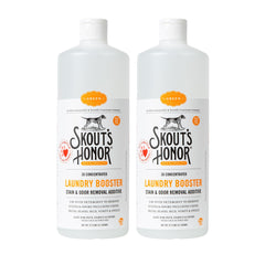Skout's Honor Laundry Booster bottle pour showing plant-powered stain removal for pet fabrics