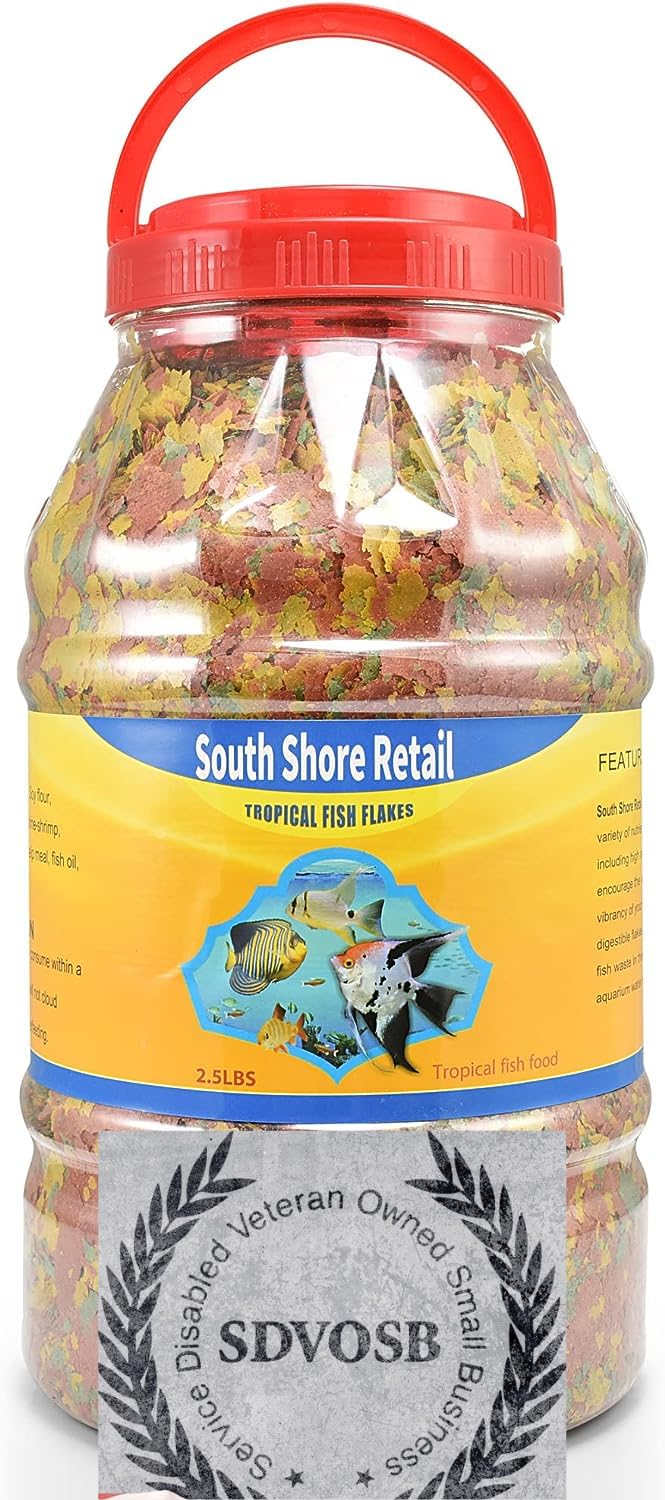 South Shore Retail tropical fish flakes close-up shows whitefish-based formula for healthy protein.