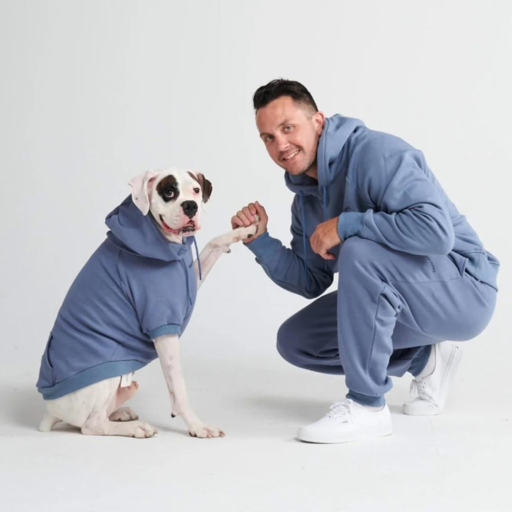Spark Paws human hoodie with drawcord hood enhances adjustable warmth during outdoor activities.