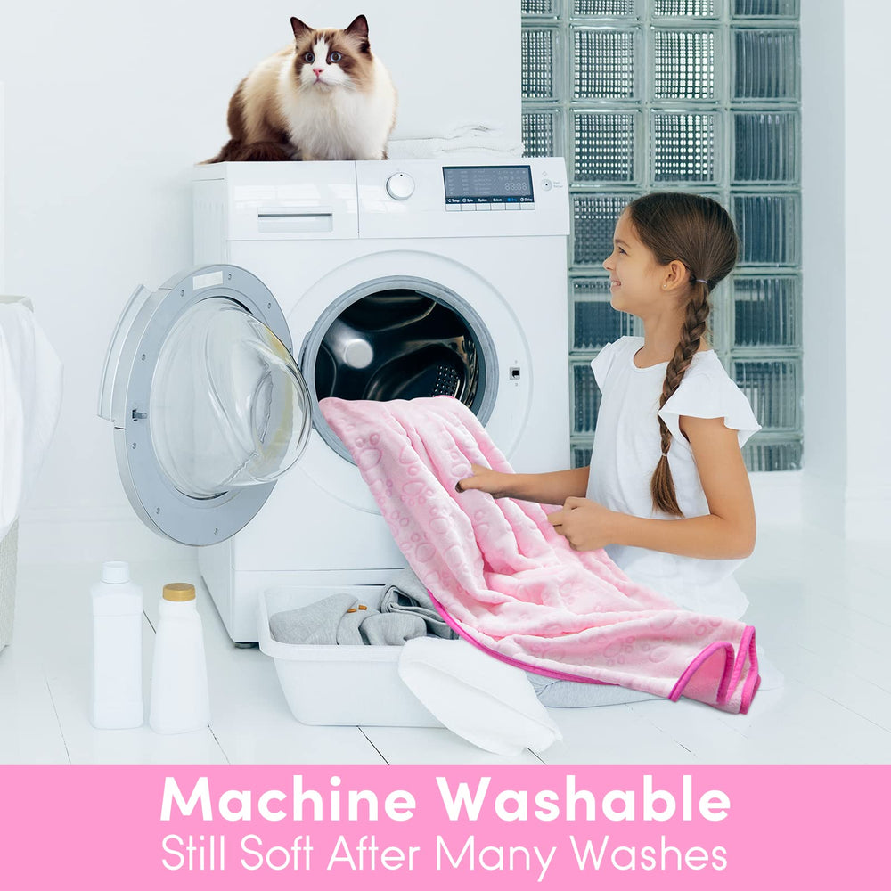 Stuffed pink cat blanket on sofa protects furniture from fur and mess