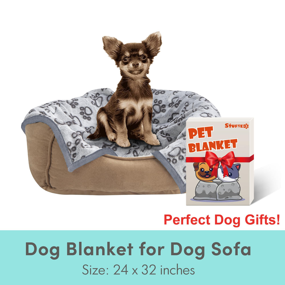 Stuffed small dog blanket on sofa protecting furniture during snuggle.