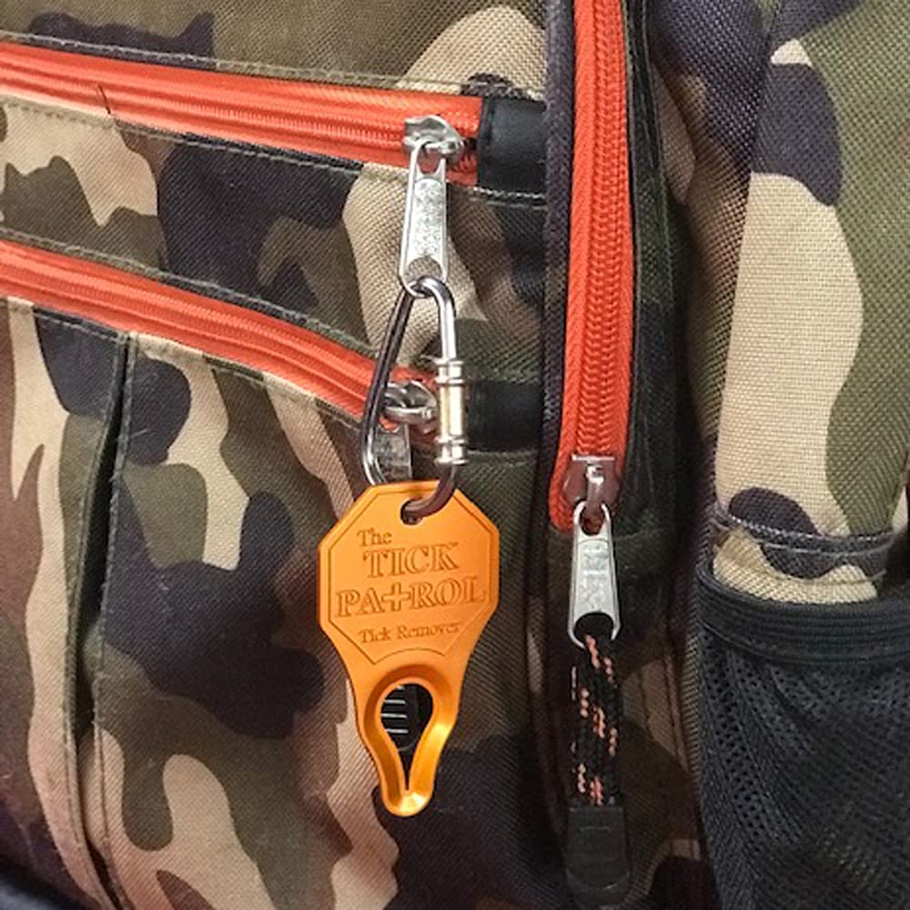 The Tick Patrol tick remover being used safely during outdoor activity