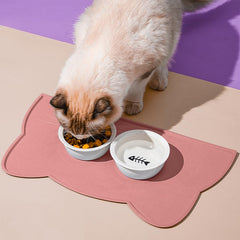 TOKAYIFE cat food mat under bowls on a hard floor, preventing messes during feeding.