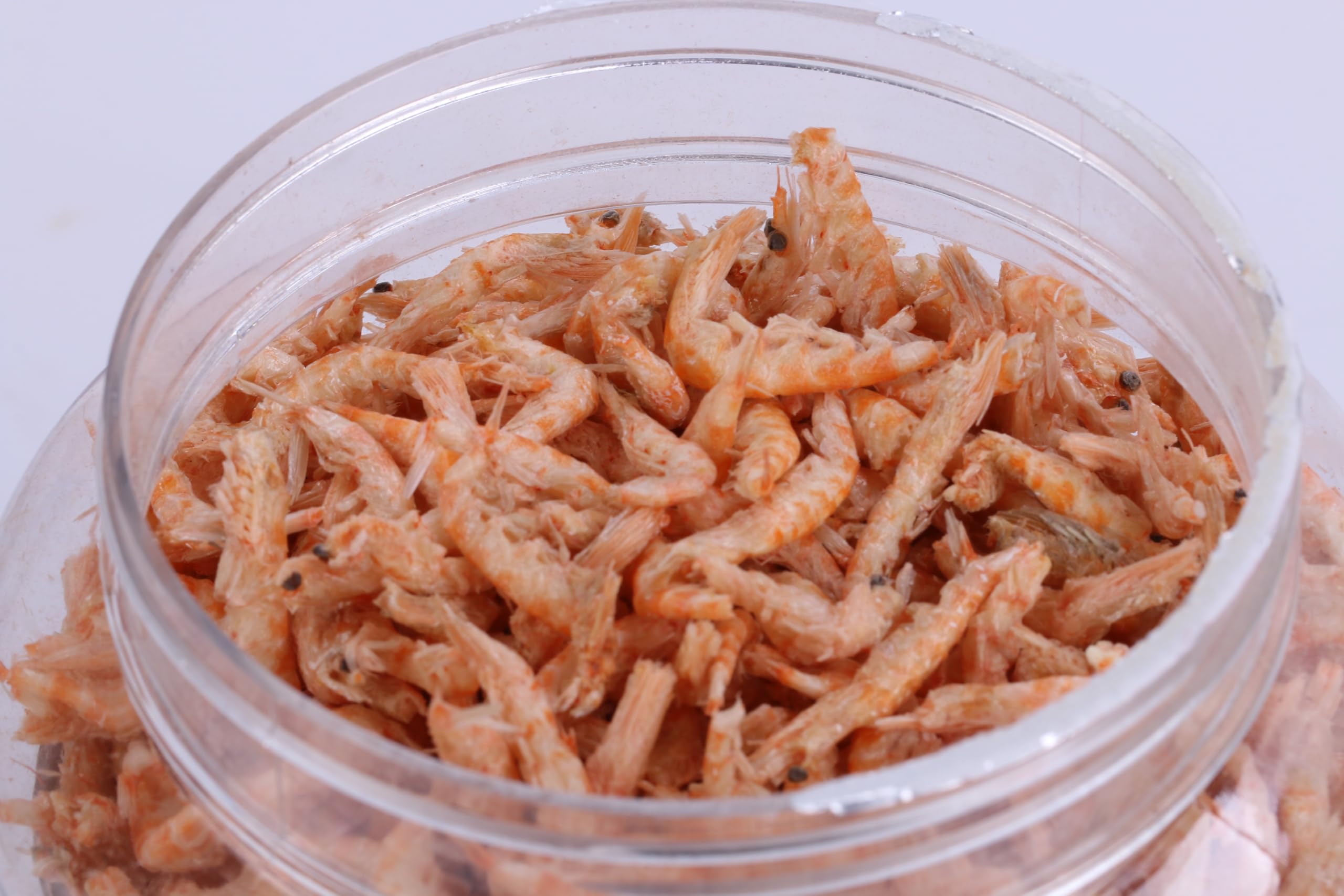 Toyuto premium freeze-dried krill shrimp mix in an aquarium dish for feeding.