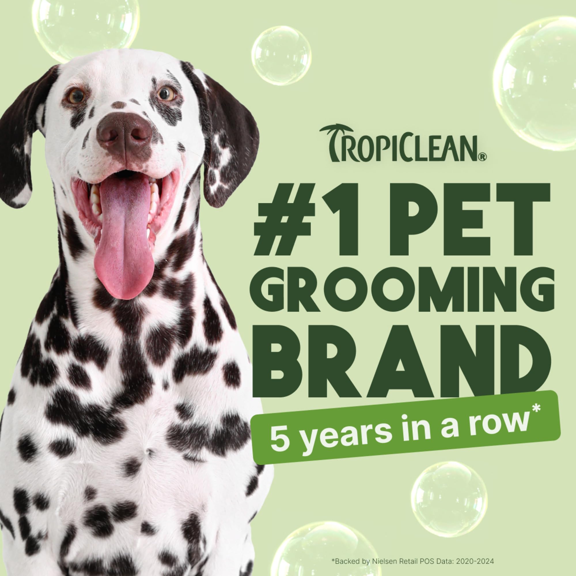 TropiClean deodorizing dog shampoo with aloe coconut scent shown beside a clean coat.