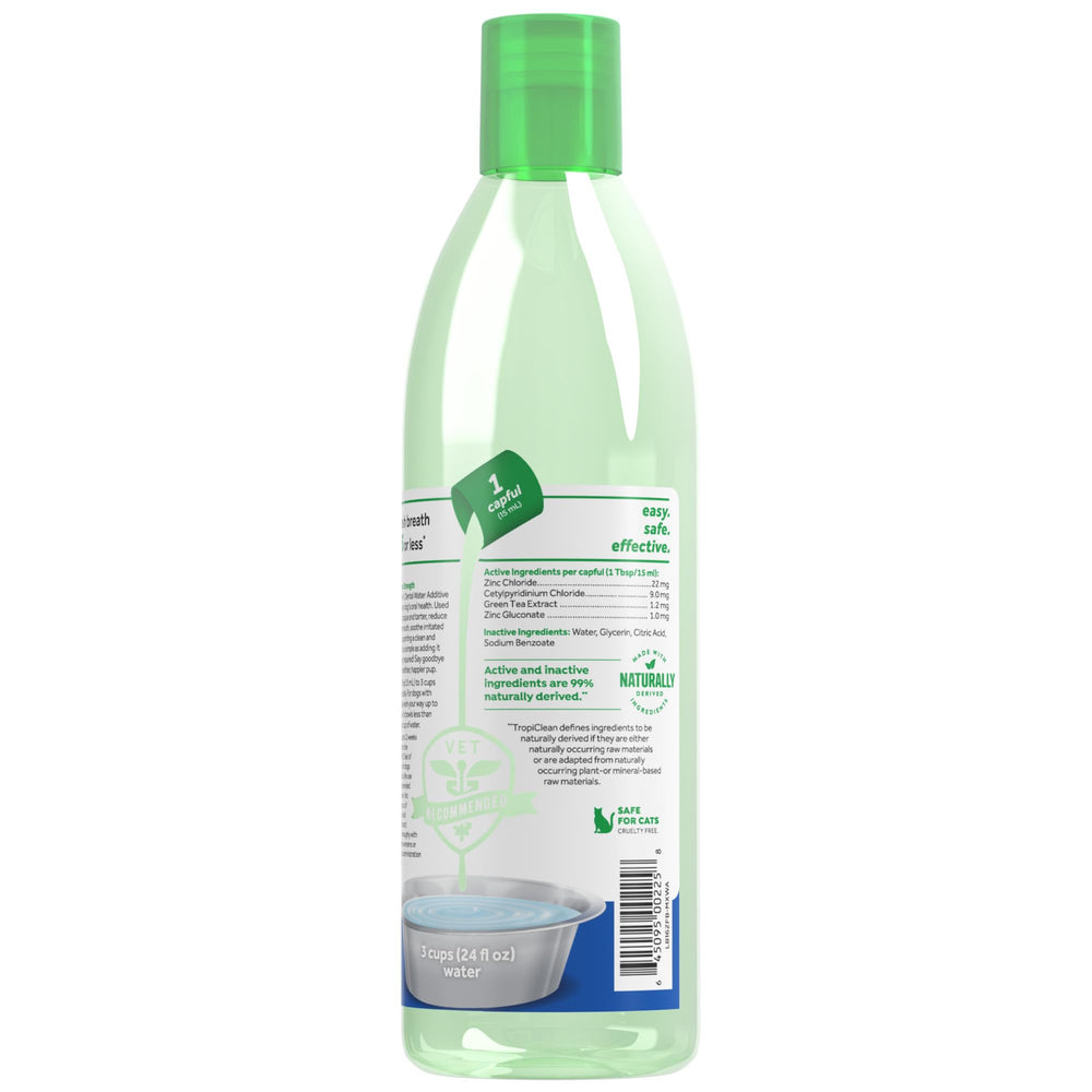 TropiClean Fresh Breath Advanced bottle in use during a dog's dental routine.