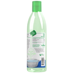 TropiClean Fresh Breath Advanced bottle in use during a dog's dental routine.