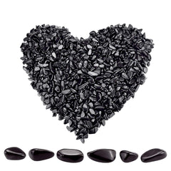 Twdrer black obsidian chips closeup showing irregular shapes for decor and crafts.