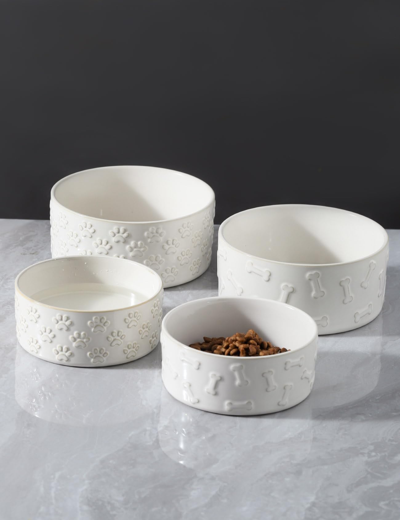 UBEE two-pack feeding bowls with bone or paw patterns, ideal for pets' meals