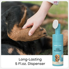 Uproot Clean bristle brush on paws highlighting gentle scrubbing.