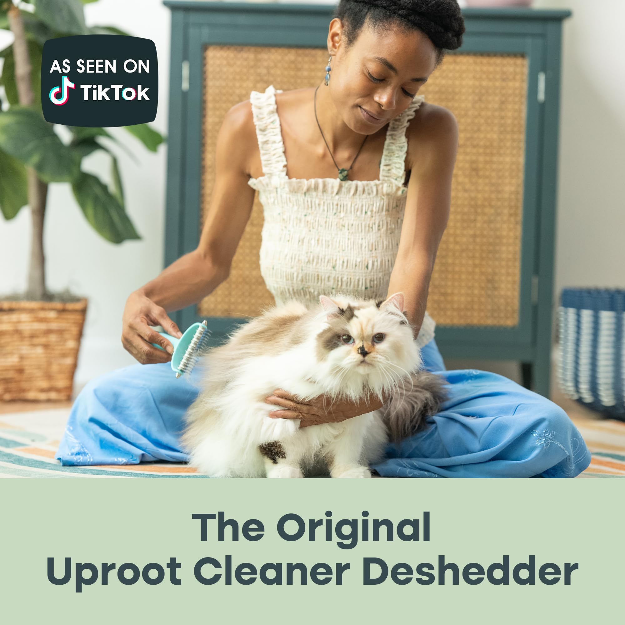 Uproot Clean Undercoat Rake removable head closeup highlights easy cleaning after grooming.