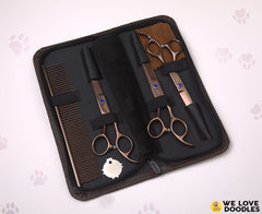 We Love Doodles dog comb detangling fur before trimming for smoother cuts.
