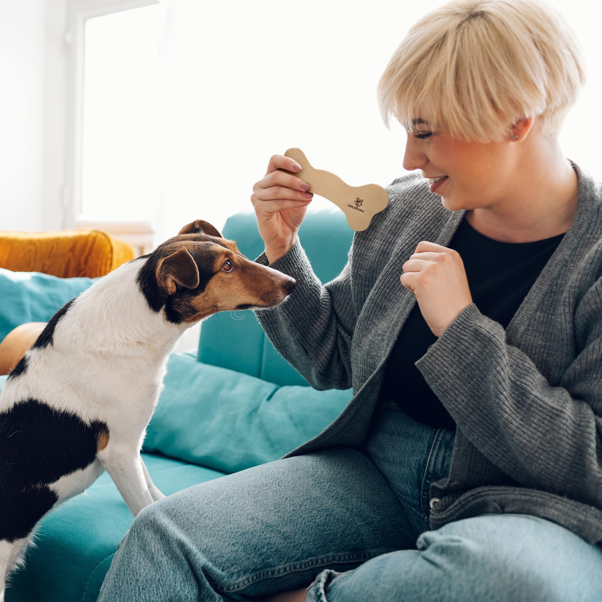 Wildfang leather bone small training chew shown with toy usage