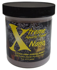 Small fish in a tank approaching sinking Xtreme Nano pellets during feeding