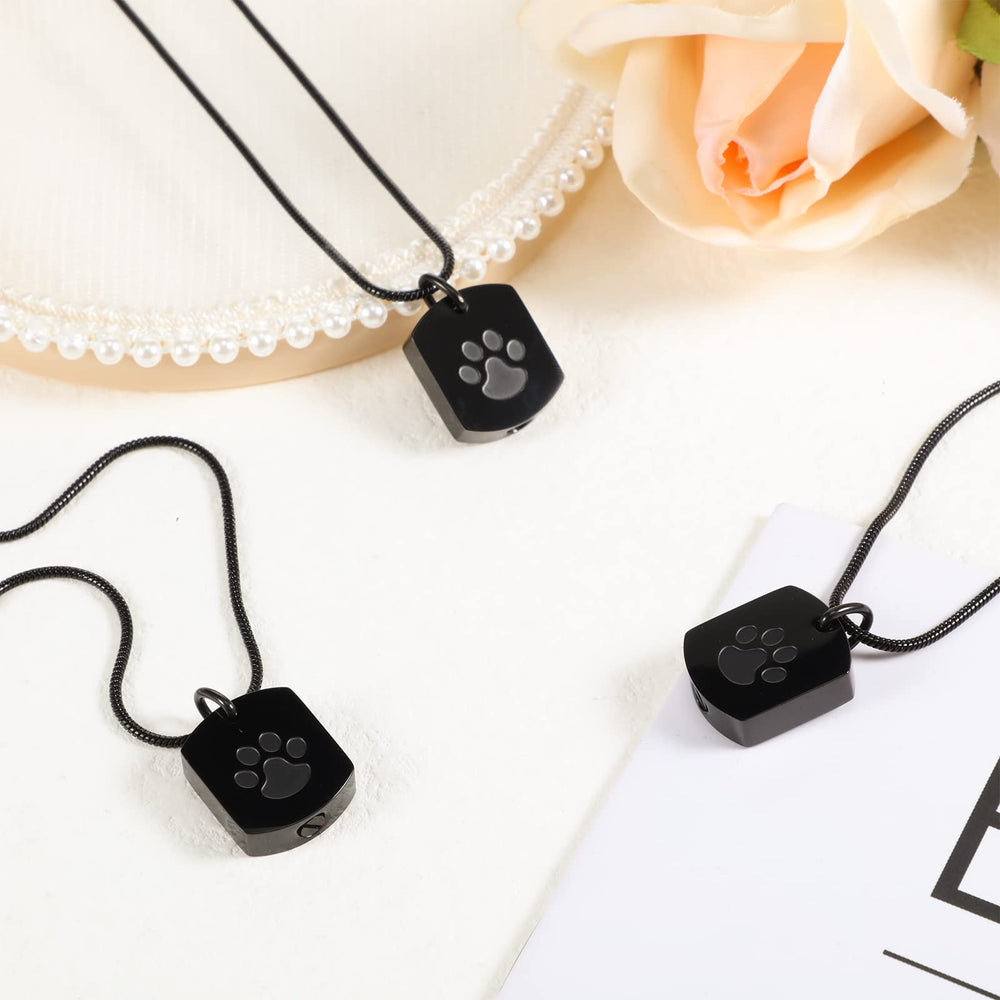 Yinkin paw print detail on urn necklace enhances memorial touch.
